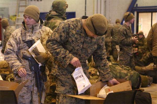 Marines with 2nd Supply Battalion, Combat Logistics Regiment 25, 2nd Marine Logistics Group take Meals, Cold Weather during the drawdown of Cold Response 14 at Evenes, Norway, March 19, 2014.