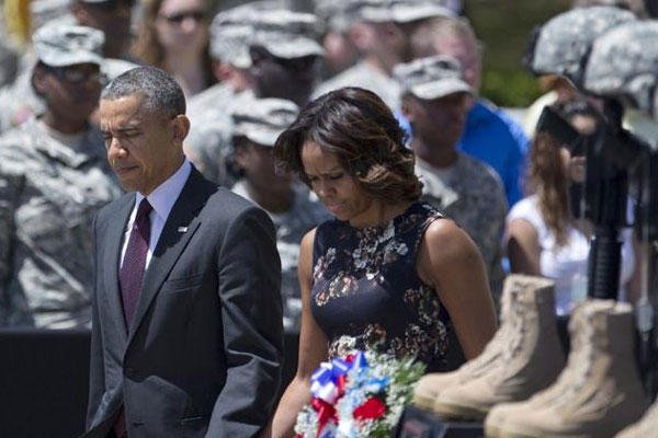 President Barack Obama and first lady Michelle Obama arrive for a memorial ceremony, Wednesday, April 9, 2014, at Fort Hood Texas, for those killed there in a shooting last week. (AP Photo/Carolyn Kaster)