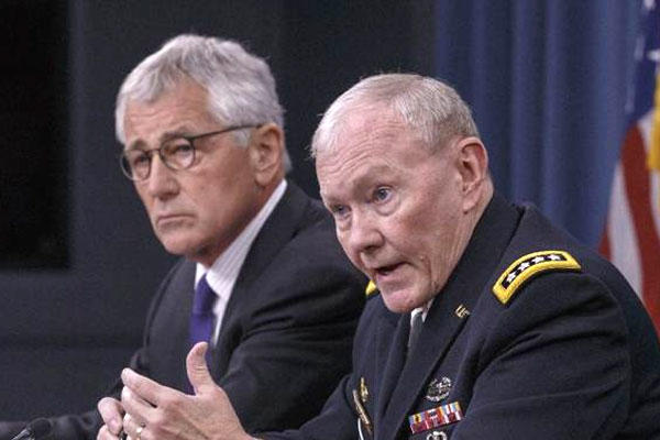 Joint Chiefs Chairman Gen. Dempsey, accompanied by Defense Secretary Hagel, brief reporters about ongoing operations against Islamic extremists in Syria and Iraq at the Pentagon, Friday, Sept. 26, 2014 (AP Photo/J. Scott Applewhite)