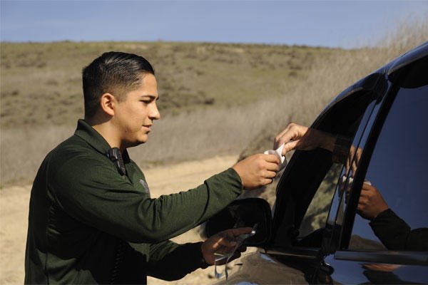 Staff Sgt. Michael Vera checks a hunter’s credentials, Dec. 9, 2014, at Vandenberg Air Force Base, Calif. (U.S. Air Force photo/Airman 1st Class Ian Dudley)
