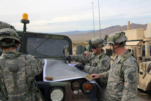 Soldiers conduct an area analysis using a map during Decisive Action Rotation 15-03 at the National Training Center at Fort Irwin, Calif., Jan. 28, 2015.(U.S. Army photo)