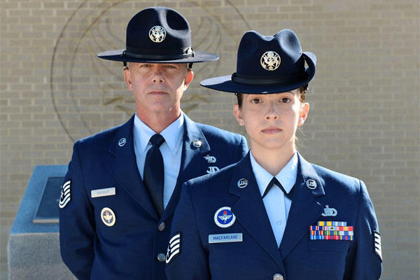Tech. Sgt. James MacKay and his daughter, Staff Sgt. Amanda MacFarlane, 433rd Training Squadron military training instructors, pose for a photo on March 27, 2015, at Joint Base San Antonio-Lackland, Texas. (U.S. Air Force photo/Benjamin Faske)
