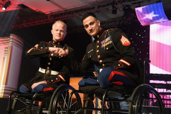 Cpl. Justin Gaertner and Sgt. Gabriel Martinez in their dress blues bumped fists as they did in Afghanistan and in recovery. (Source: ICE) 
