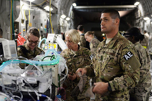 Tech. Sgt. Russell McLamb assists with the loading of an injured service member on a C-17 Globemaster III at Bagram Airfield, Afghanistan. (U.S. Air Force/Maj. Tony Wickman)