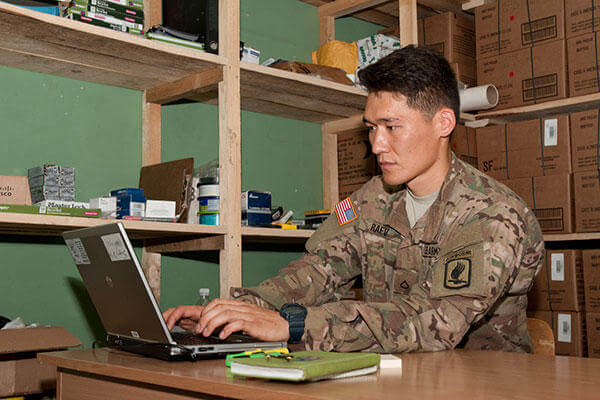 U.S. Army Pfc. Aidarbek Raev updates unit supply inventory records in Panevezys, Lithuania. Raev is Dog Company’s supply specialist and performs the duties of a soldier three tiers above his current rank. (U.S. Army/Sgt. Jarred Woods)