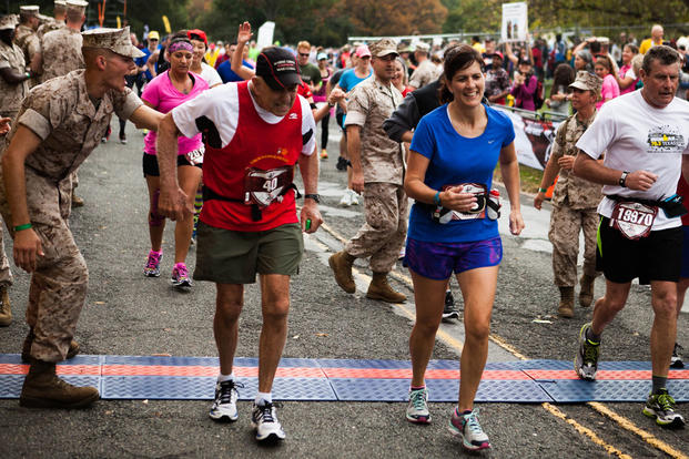 Marine Col. (ret) Al Richmond, center-left, one of the two final “Groundpounders,” completes the 40th Marine Corps Marathon at Arlington, Virginia, Oct. 25, 2015. (Photo By: Sgt. Justin M. Boling)