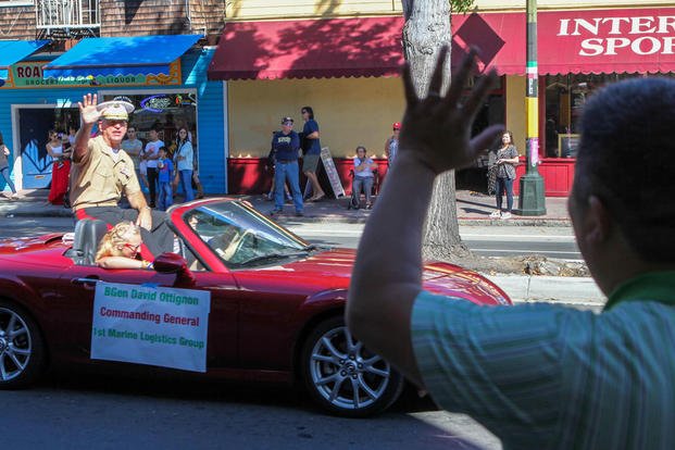 Brig. Gen. David Ottignon, the commanding general of 1st Marine Logistics Group, waves to San Francisco residents during the Italian Heritage parade Oct. 11, as part of San Francisco Fleet Week 2015 Photo By: Cpl. Joshua Murray