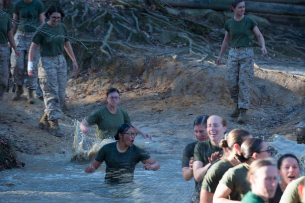Candidates in Officer Candidate School jump into a muddy pit right before receiving their Eagle, Globe and Anchor at Marine Corps Base Quantico, Virginia, Nov. 20, 2015. (Photo: Sgt. Eric Keenan)