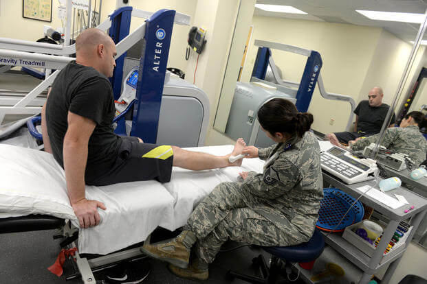 Master Sgt. Shannon Stoner, a physical therapy technician, performs an ultrasound on Staff Sgt. Christopher Bonds, Nov. 18, 2015, at Seymour Johnson Air Force Base, N.C. (Photo: Airman 1st Class Ashley Williamson)