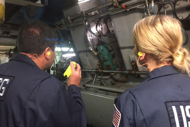 Chief Warrant Officer Martin Donohue teaches Lt. j.g. Katharine Martorelli how the fuel system works on the main engine during a ship ride event Dec. 8, 2015. (Photo: Chief Warrant Officer Israel Nieves)