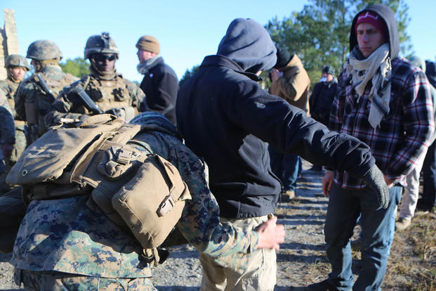 Marines with 2nd Battalion, 2nd Marine Regiment search refugee role players for any contraband that the refugees may be attempting to hide during a noncombatant evacuation training operation Jan. 14, 2016. (Photo: Lance Cpl. Shannon Kroening)