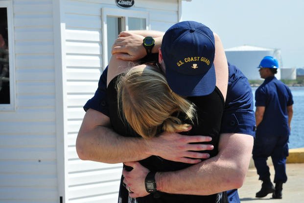 A Coast Guard Cutter Tampa crew member embraces his wife on the pier at Base Portsmouth, Virginia, April 27, 2016. (Photo: Petty Officer 1st Class Melissa Leake)