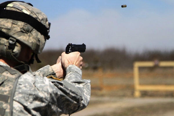 U.S. Army Sgt. Angel Suarezelias, assigned to 11th Aviation Command, shoots an M9 at a target as part of the joint Best Warrior Competition hosted by 84th Reserve Training Command at Ft. Knox, Ky., March 22, 2016. (Photo by Josephine Carlson/U.S. Army)