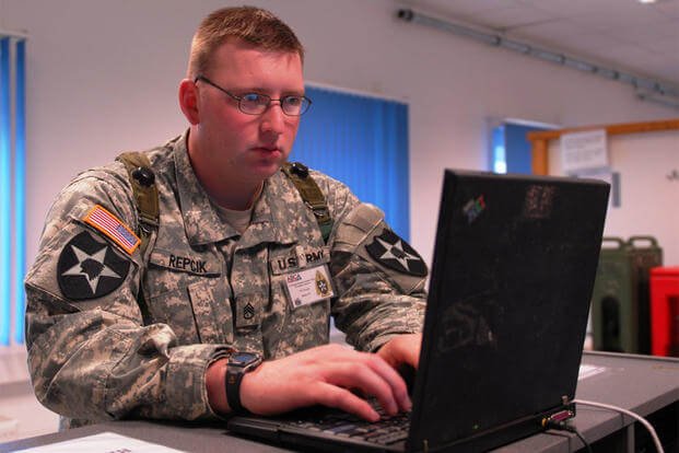 Staff Sgt. Adam D. Repcik, an information security officer, works on a laptop computer during Cooperative Spirit 2008 at the Joint Multi-National Readiness Center near Hohenfels, Germany. (Photo: Sgt. Warren Wright)