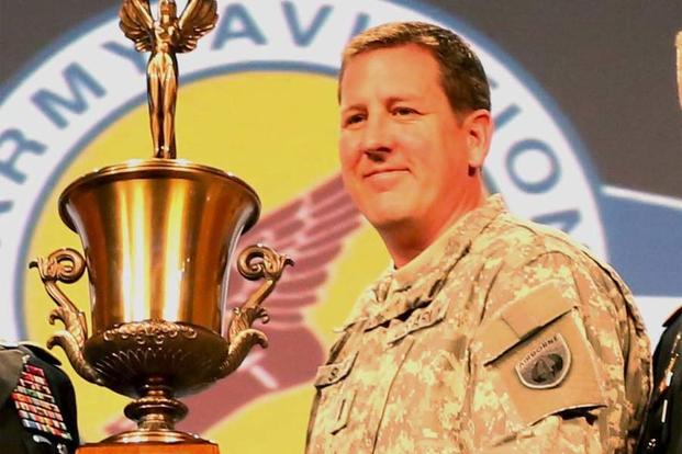 Chief Warrant Officer 4 Michael Siler accepts the Michael J. Novosel Army Aviator of the Year Award during the 2015 Army Aviation Mission Solutions Summit at the Gaylord Opry Convention Center in Nashville, Tenn. (160th SOAR Public Affairs)