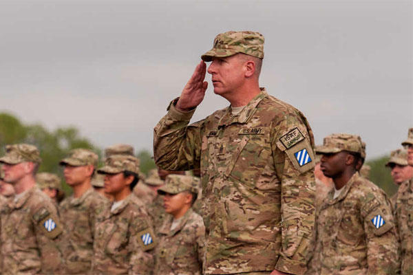 Army Command Sgt. Maj. Alan Hummel salutes as he leads a group of about 300 soldiers with the 3rd Infantry Division’s 4th Infantry Brigade Combat Team (Army Photo)