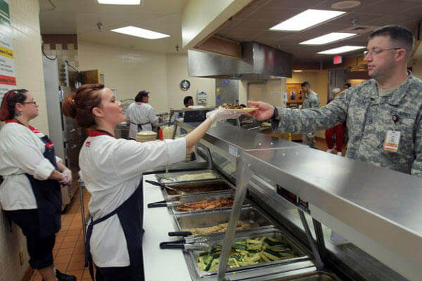 Elyce Thomas, Reynolds Army Community Hospital dining facility cook, serves lunch at the DFAC Feb. 20, 2015. (Photo Credit: Jeff Crawley, Fort Sill Cannoneer)