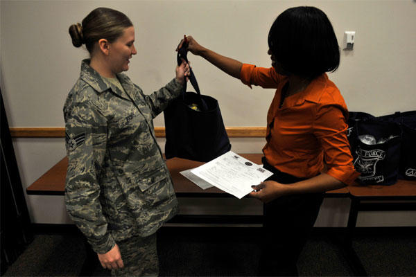 Airman receives a bundle from an Airman and Family Readiness Center community readiness consultant, after the Bundles for Babies seminar Jan. 23, 2013, at Buckley Air Force Base, Colo. (U.S. Air Force photo by Airman 1st Class Riley Johnson/Released)