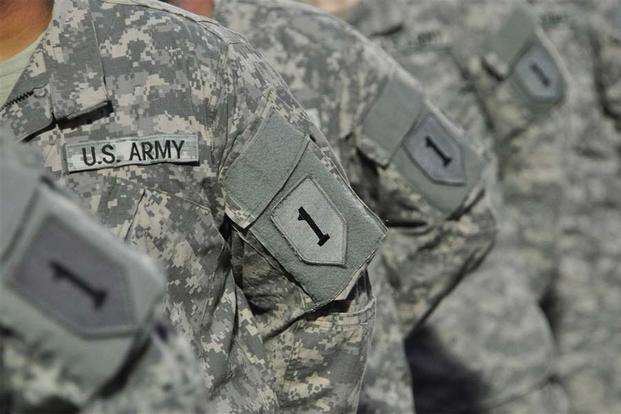 FILE -- About 350 U.S. Army Soldiers with 1st Infantry Division received their combat patches during a ceremony at turf field, Camp Lemonnier, Djibouti, July 27, 2013.. (U.S. Air Force photo/Tech. Sgt. Chad Thompson)