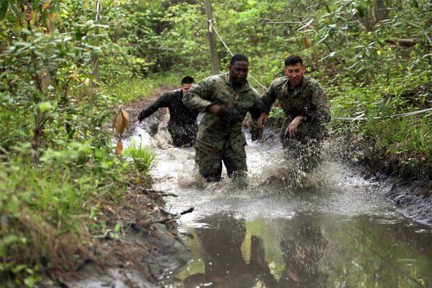 Marines with Combat Logistics Regiment 2 splash their way through one of the many mud puddles during an endurance course at Camp Lejeune, N.C., April 22, 2016. (Marine Corps/ Lance Cpl. Brianna Gaudi)