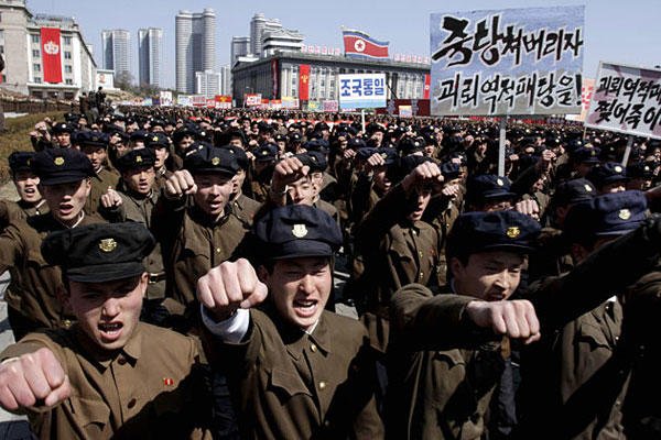 University students punch the air as they march through Kim Il Sung Square in downtown Pyongyang, North Korea, Friday, March 29, 2013. Tens of thousands of North Koreans turned out for the mass rally at the main square in Pyongyang.