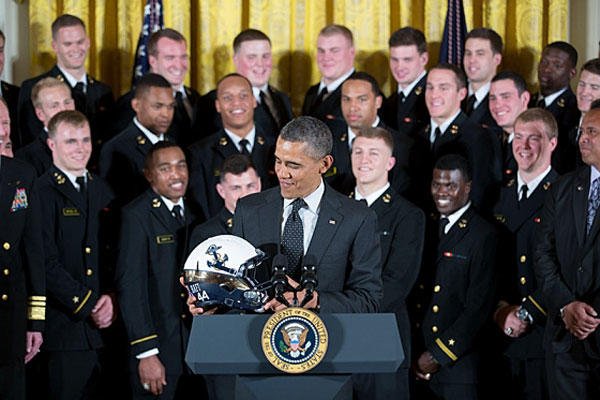 President Obama accepts a Naval Academy helmet in May as he greets the football team to the White House after the Navy football team won the 2012 Commander-in-Chief's Trophy.