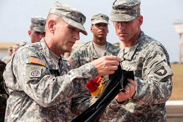 Command Sgt. Maj. Gregory Nowak, left, and Maj. Gen. Gary Volesky, commander of JFC-UA and 101st, case their unit colors during a ceremony at the Barclay Training Center, Monrovia, Liberia, Feb. 26, 2015. Photo by Spc. Rashene Mincy