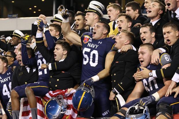 Navy football players celebrate after defeating Army in the annual rivalry for the 14th time in a row. The game was a thriller that saw The Black Knights ahead of The Midshipmen at halftime. (Photo by Steve Whitman/Military.com)