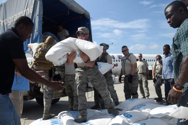 Staff Sgt. Angelo Morino, 621st Contingency Response Wing, transports food and provisions for Hurricane victims, October 9th, 2016, Port-Au-Prince, Haiti. (U.S. Air Force photo/Robert Waggoner)