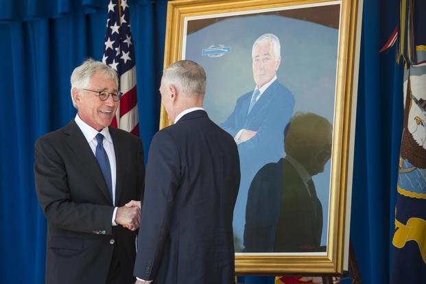 Defense Secretary Jim Mattis and former Defense Secretary Chuck Hagel attend the unveiling ceremony of Hagel’s official portrait at the Pentagon on May 19, 2017. Tech. Sgt. Brigitte N. Brantley/Air Force