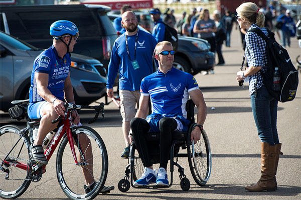 Ashley Means stands by her husband Jeremiah as they talk to other Air Force wounded warriors at the Warrior Games cycling event, Sept. 9, 2014, at Fort Carson, Colo. Senior Airman Jette Carr/Air Force