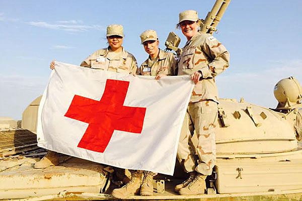 Navy wife Jennifer Cole (left) poses with her American Red Cross team at Camp Arifjan, Kuwait. Photo courtesy American Red Cross