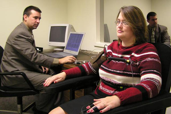 Polygraph test in an office while sitting in a chair.