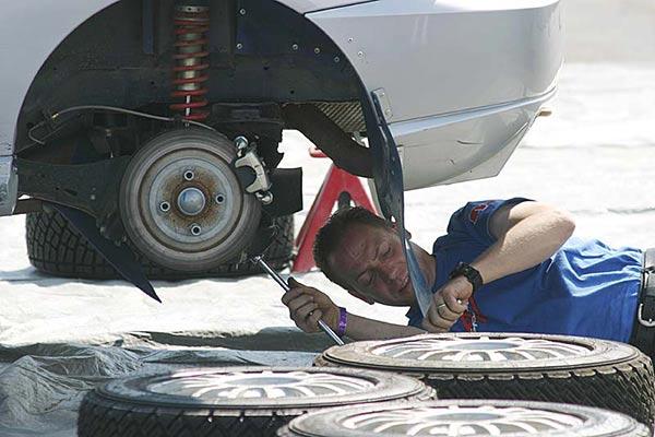 An auto mechanic working on a rally car. (Photo courtesy Wikimedia Commons)