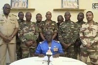Col. Maj. Amadou Abdramane sits in front of military men in in Niamey, Niger.