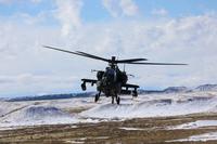 AH-64 Apache helicopter flies over Fort Carson