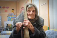 98-year-old Lidia Lomikovska sits in a shelter after she escaped Russian-occupied territory