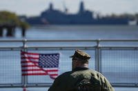 John Robertson, Navy and Marine Corps veteran, watch the U.S. Navy ships pass the viewing stand during the 250th anniversary of the founding of the U.S. Navy and Marine Corps, along the Delaware River, Thursday, Oct. 9, 2025, in Philadelphia. (AP Photo/Matt Rourke) John Robertson, Navy and Marine Corps veteran, watch the U.S. Navy ships pass the viewing stand during the 250th anniversary of the founding of the U.S. Navy and Marine Corps, along the Delaware River, Thursday, Oct. 9, 2025, in Philadelphia. (AP Photo/Matt Rourke)