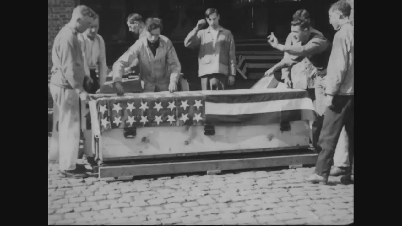 Army officers with a casket.