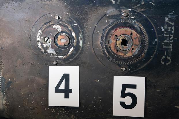 Two of nine valves found on Qiam-class missile remnants provide evidence of its origin as part of a display at Joint Base Anacostia-Bolling in Washington, D.C., Dec. 12, 2017. DoD photo by EJ Hersom