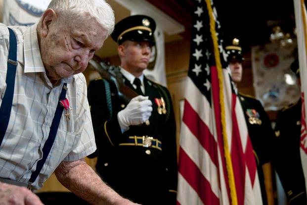 Martin L. Paulson, a World War II veteran, stands by the I Corps Honor Guard during an award ceremony in Westport, Wash., Aug. 30, 2013. (U.S. Army/Staff Sgt. Miriam Espinoza Torres)