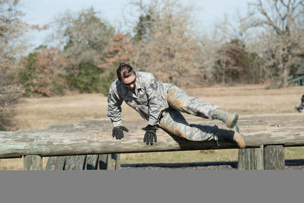Air Force Tech. Sgt. Jennifer Brown, an education and training specialist with the Texas Air National Guard’s 273rd Cyber Operations Squadron, jumps over an obstacle during the 2018 Best Warrior Competition near Bastrop, Texas, March 1, 2018. (Texas Air National Guard/Agustin Salazar)