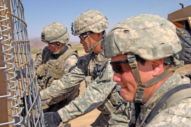 Soldiers install HESCO barriers at an Afghan police checkpoint in Robat, Afghanistan, March 19, 2010. The Soldiers are assigned to the 2nd Infantry Division's 5th Stryker Brigade Combat Team. (U.S. Army/Air Force Tech. Sgt. Francisco V. Govea II)