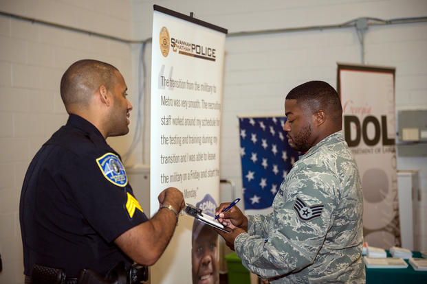 U.S. Air Force Staff Sgt. Brandon Abercrombie fills out contact information for Sgt. Julius Few.