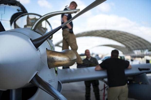 Contractors from the Sierra Nevada Corporation (SNC) perform a post-flight brief for an A-29 Super Tucano, April 24, 2018, at Moody Air Force Base, Ga. (U.S. Air Force/Airman 1st Class Erick Requadt)
