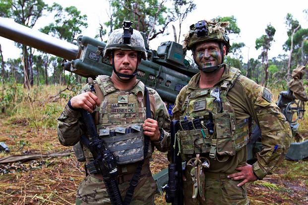 Pvt. Joshua Teneyck, an Indiana National Guardsman, and an Australian counterpart train together on an M777 howitzer during Exercise Hamel, which integrates U.S. forces into an Australian Battle Group. (U.S. Army photo by Spec. Joshua Syberg)