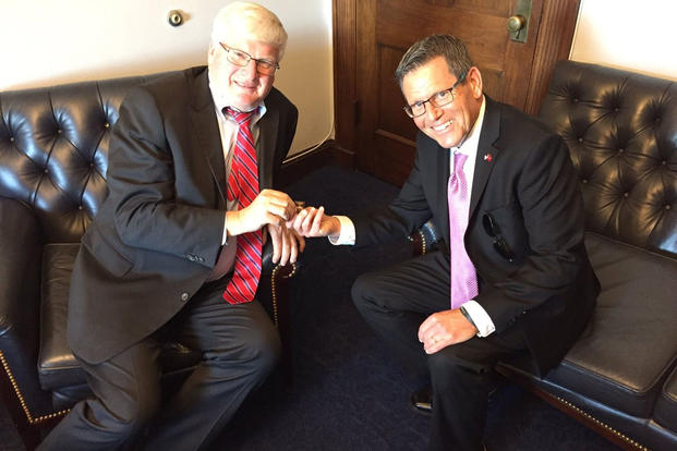 U.S. Congressman Glenn Grothman (left) discusses veterans issues with Jake Leinenkugel (right) as he presents Grothman with a Veterans Day pin. (Photo: Rep. Glenn Grothman, grothman.house.gov)