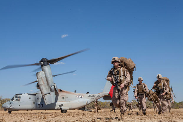 Marines and Sailors with Company E., Battalion Landing Team 2nd Battalion, 4th Marines, 31st Marine Expeditionary Unit, offload from an MV-22 Osprey with Marine Medium Tiltrotor Squadron 265 (Reinforced), 31st MEU, to participate in Exercise Koolendong 13 in Australia, Aug. 30, 2013. (U.S. Marine Corps photo/Jonathan Wright)