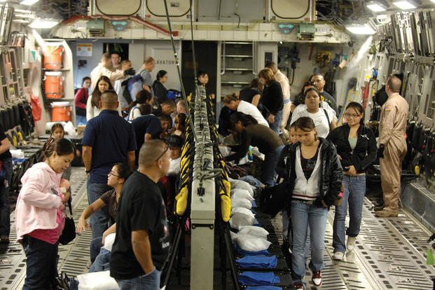 Space-available passengers board a C-17 at Hickam Air Force Base, Hawaii, bound for Andersen AFB, Guam. (U.S. Air Force/Cohen A. Young)