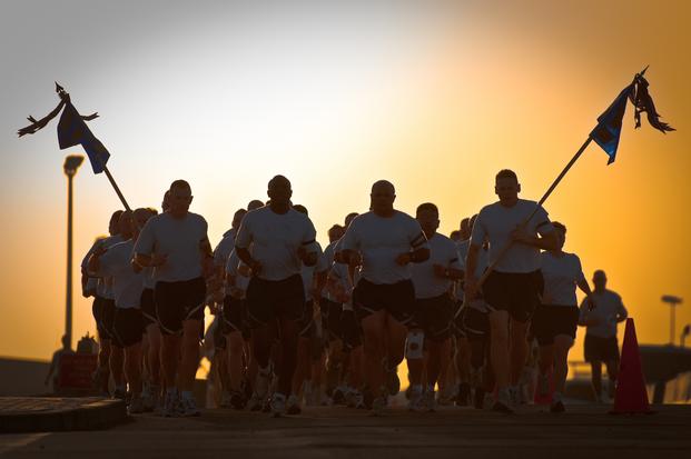 SOUTHWEST ASIA - Members of the 386th Expeditionary Mission Support Group conduct physical fitness training here June 23, 2010, as the sun rises over their base. Comprised of approximately 850 Airmen, the unit provides security forces, logistics, contracting, communications and civil engineering services as part of the 386th Air Expeditionary Wing. (Dale Greer/U.S. Air Force)